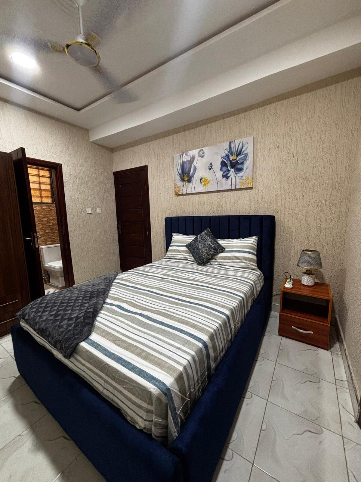 Bedroom 1 with bathroom entrance – Cape Coast Airbnb managed by Gold Lion International