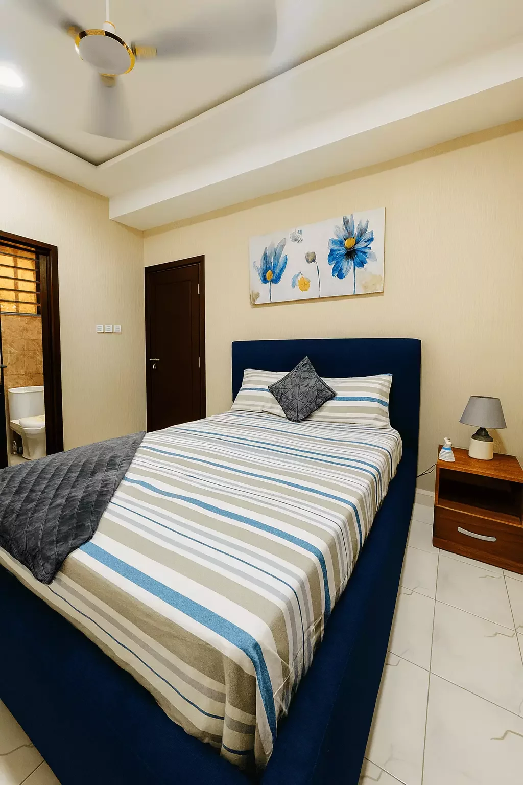 Bedroom 1  with bathroom entrance of Cape Coast Airbnb property managed by Gold Lion International